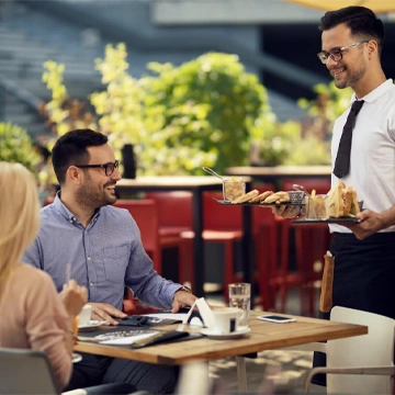 Team defining project requirements around a laptop